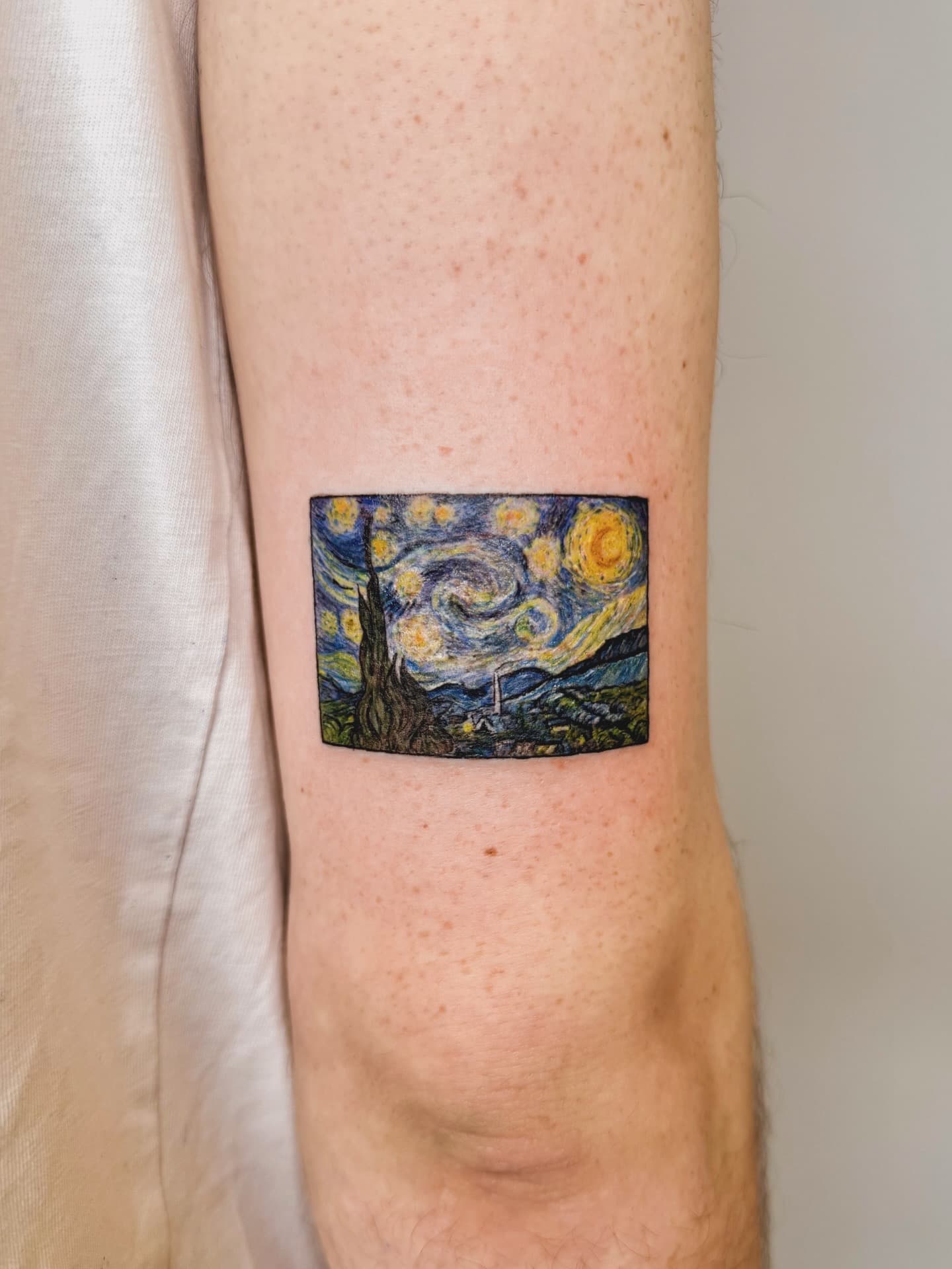 Miniature Starry Night tattoo on upper arm