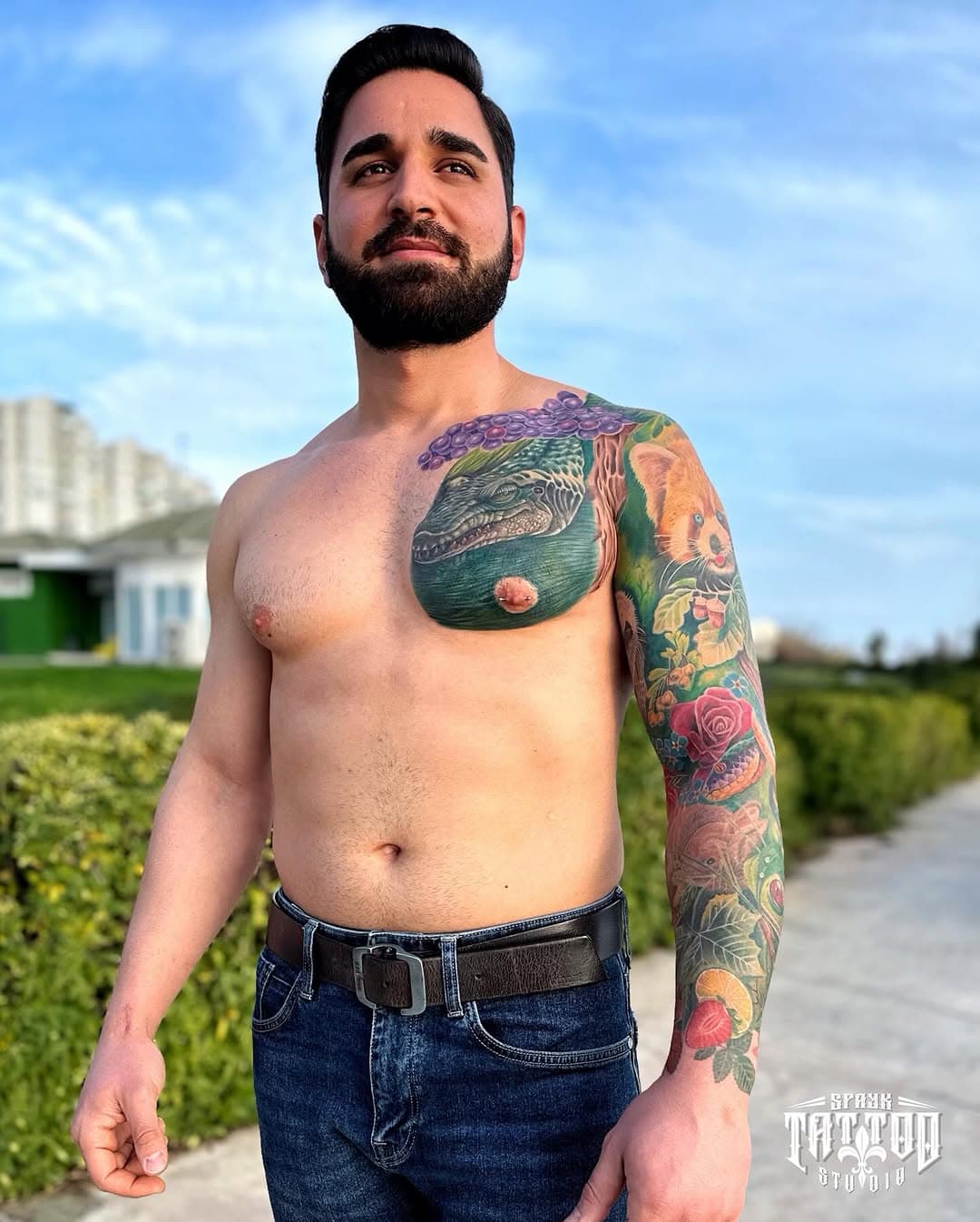Illustrative chest and sleeve tattoo