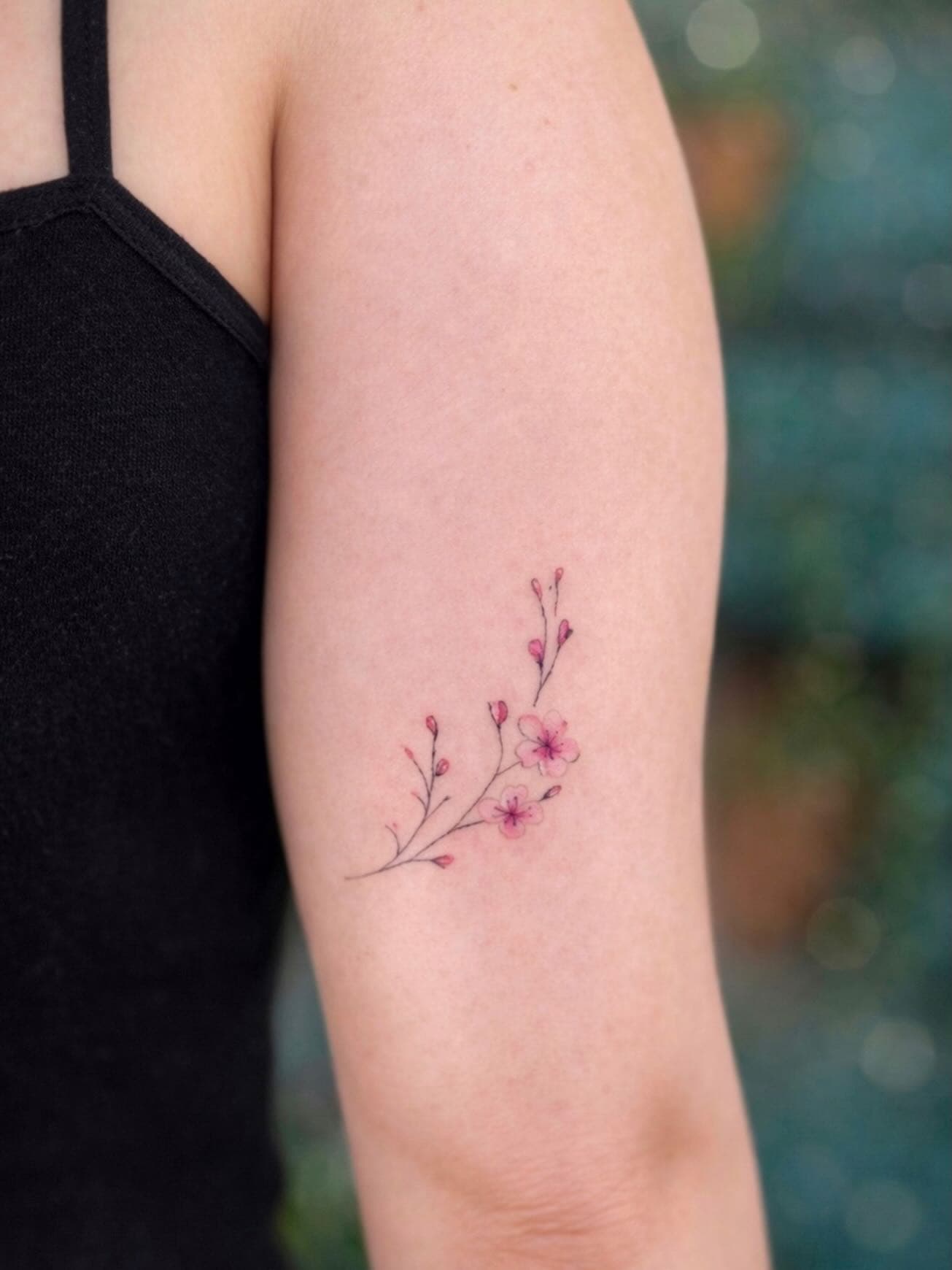 Fine line cherry blossom arm tattoo