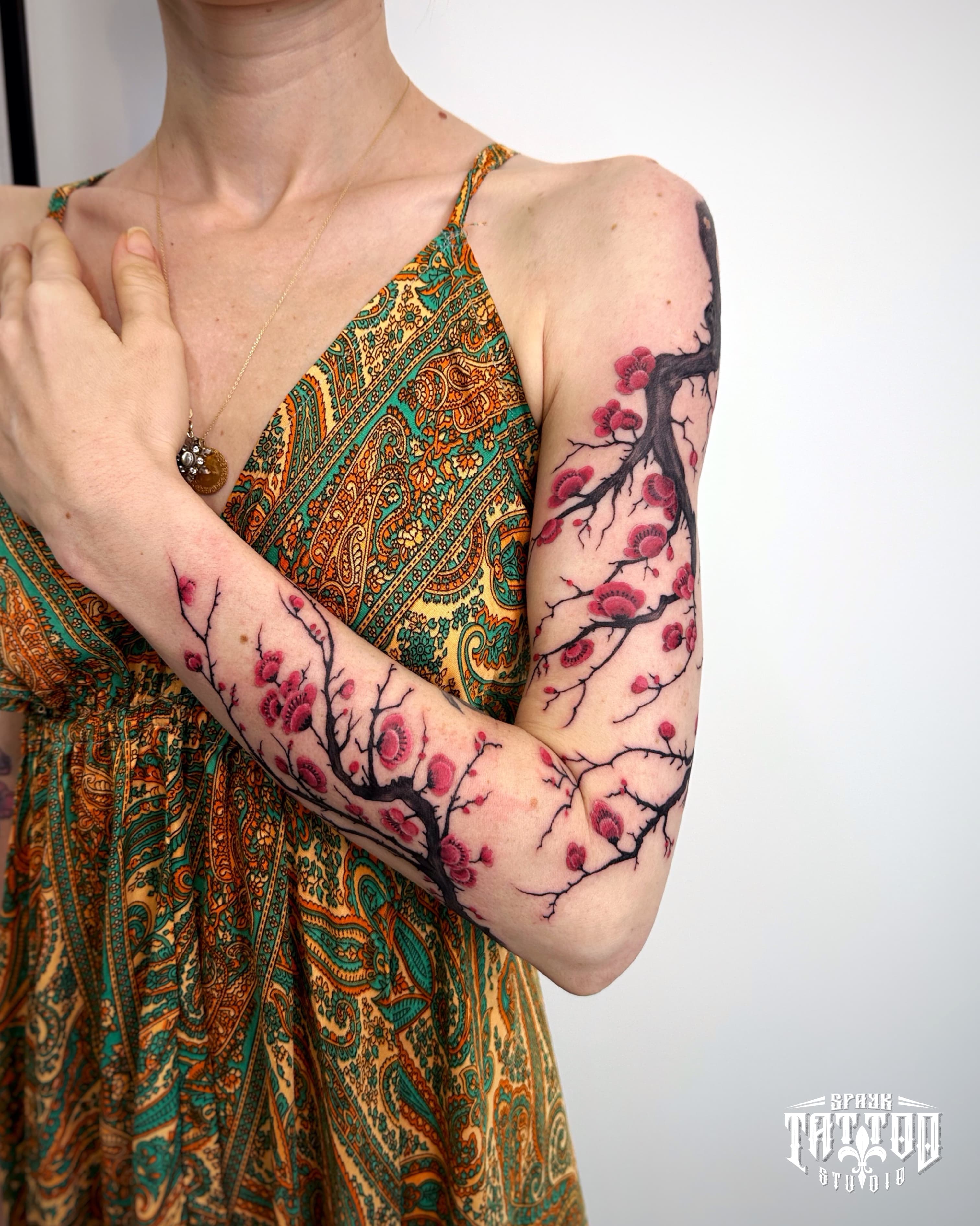 Color cherry blossom arm tattoo