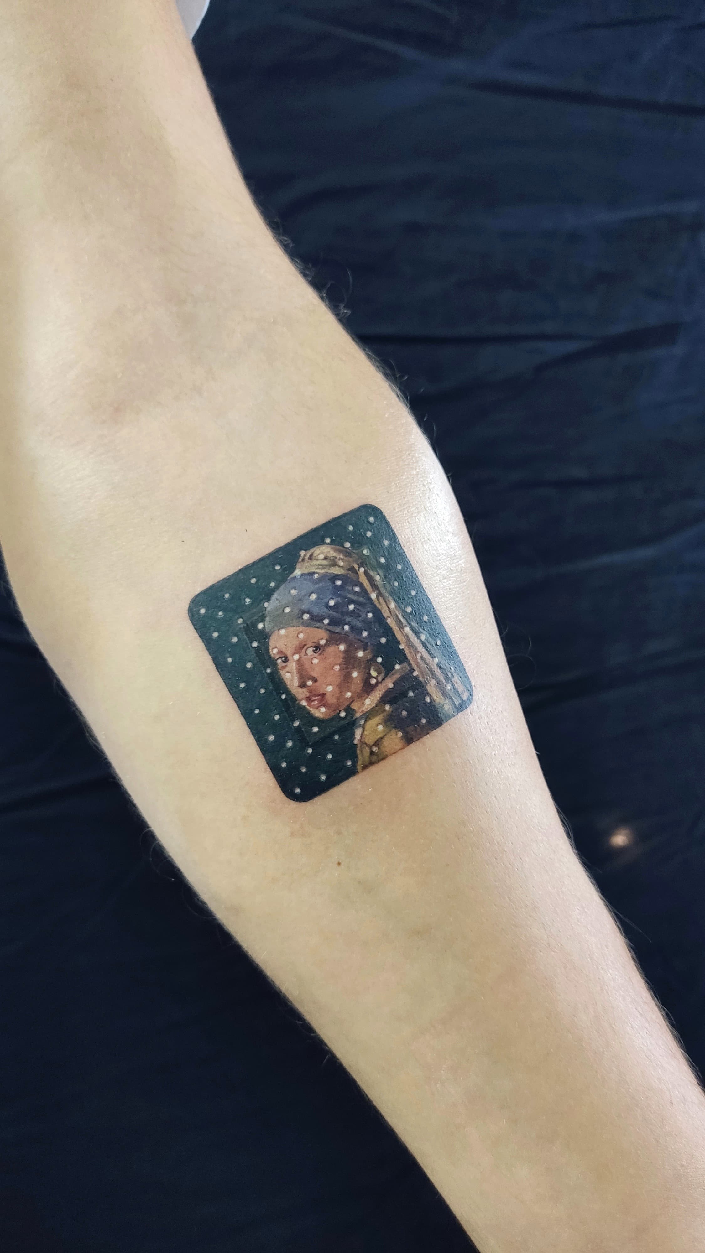 Miniature Girl with a Pearl Earring forearm tattoo