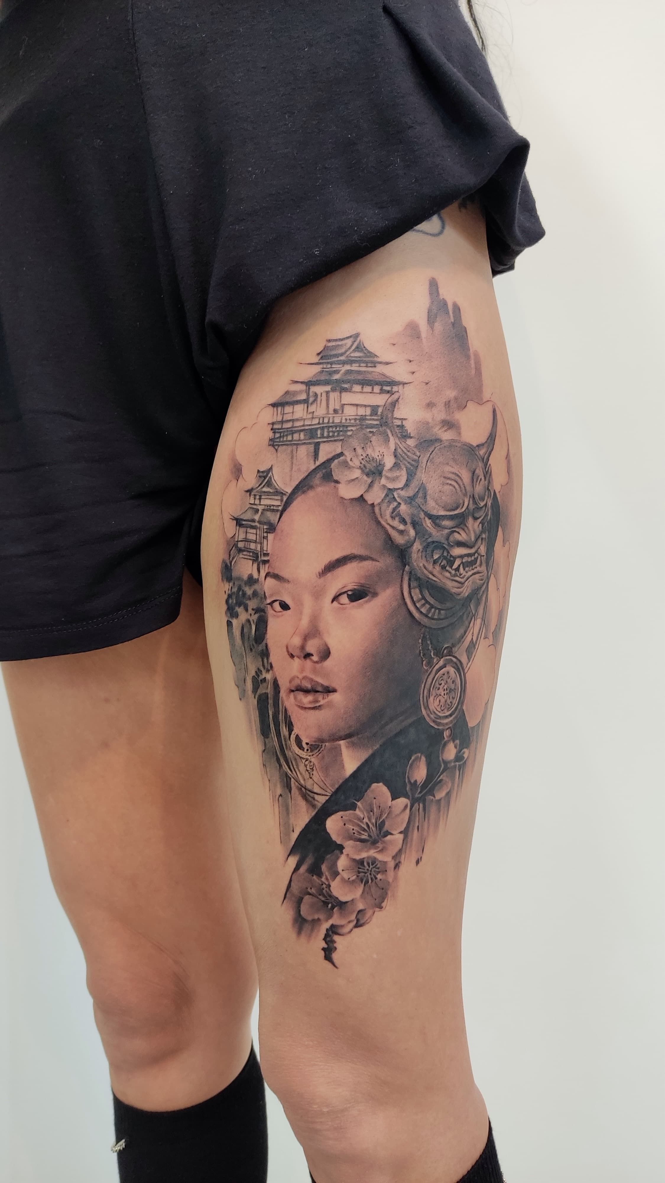 Japanese woman and hannya mask thigh tattoo