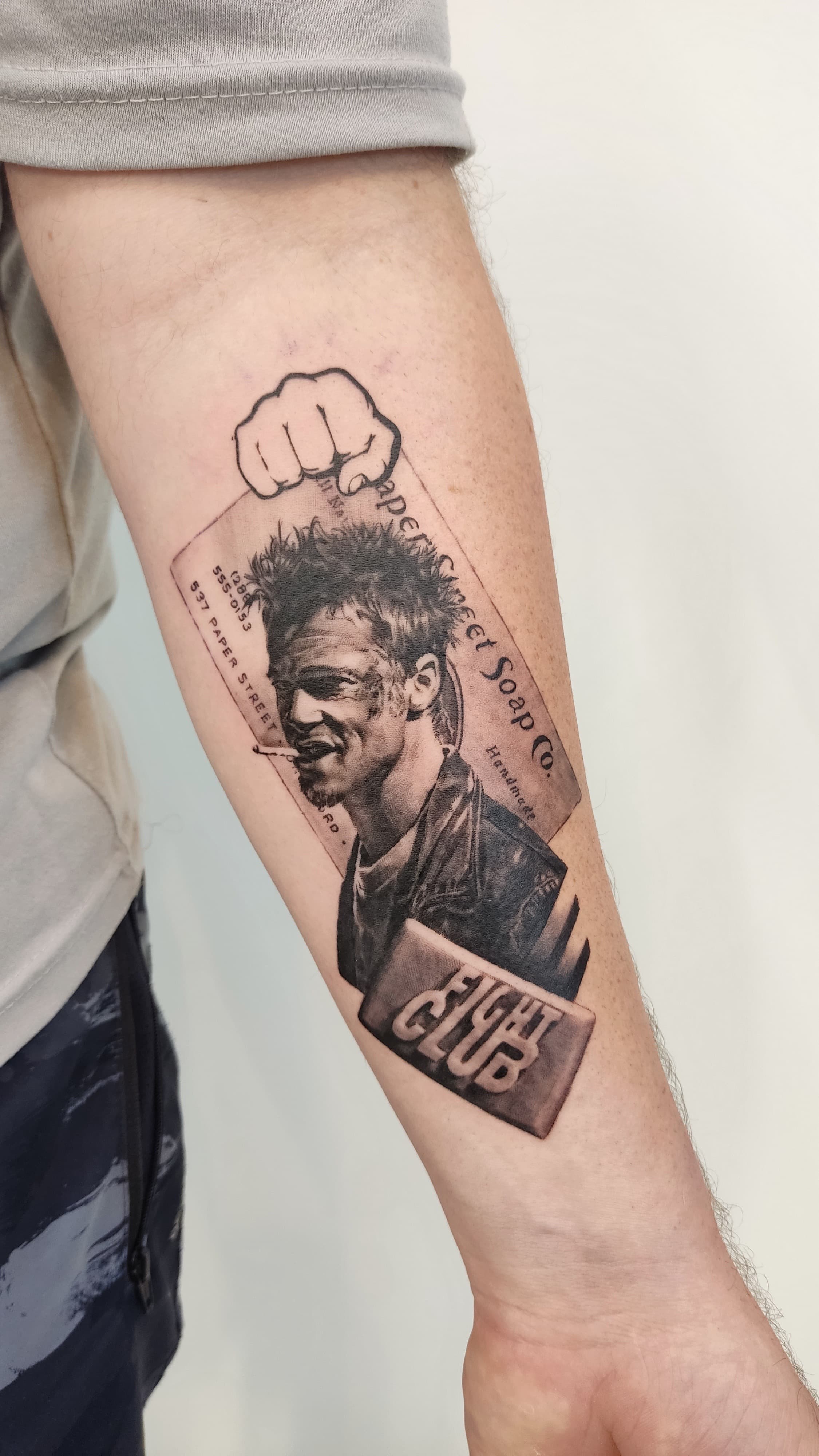 Fight Club collage forearm tattoo in black and grey